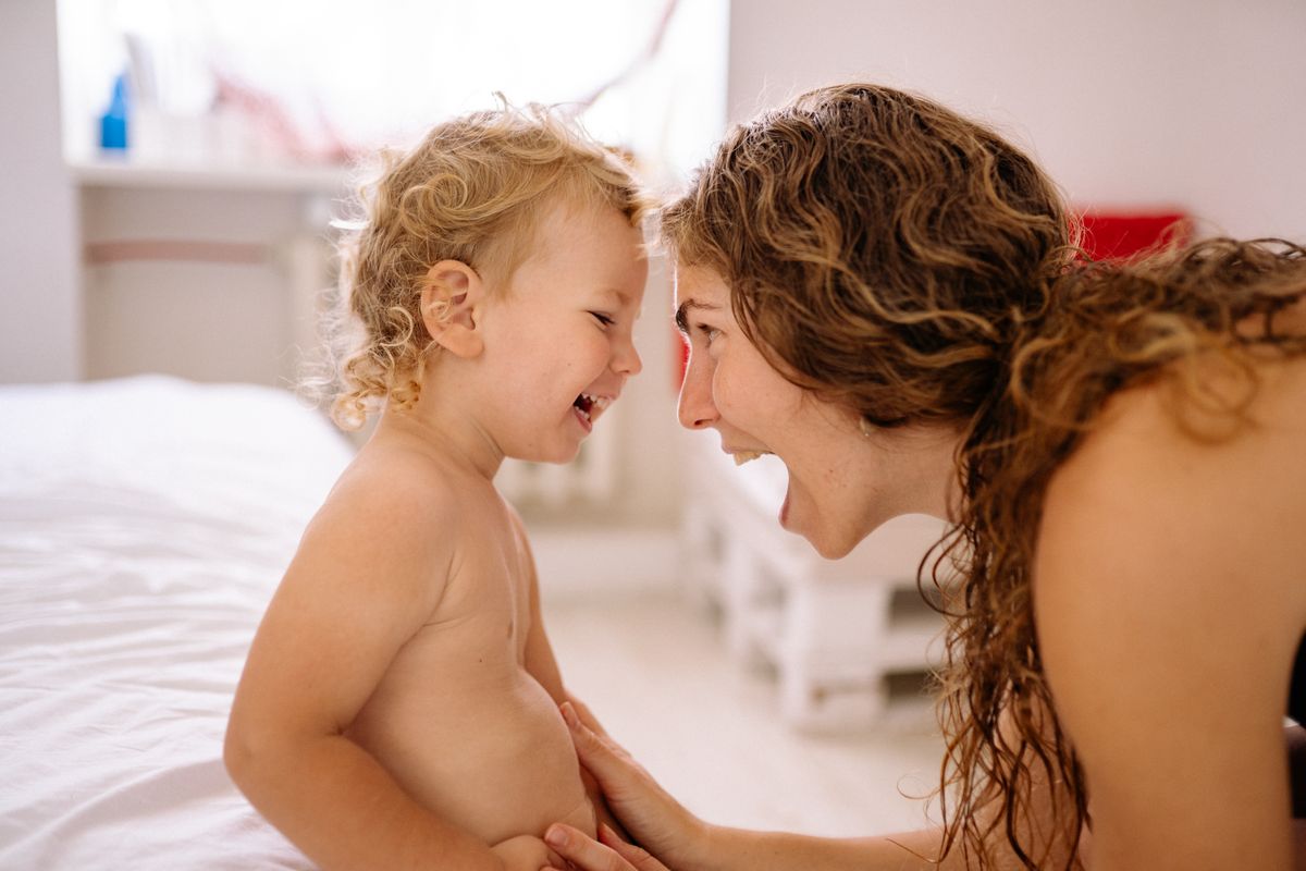 Happy Mother Playing with Child at Home