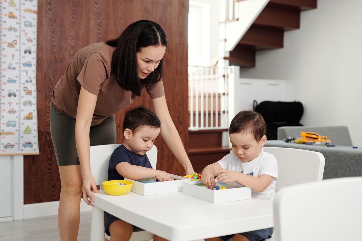 Mother and Her Children Playing at the Kitchen